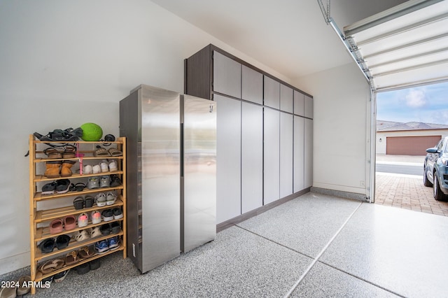 garage featuring stainless steel fridge