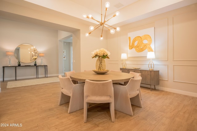 dining space featuring a chandelier and light hardwood / wood-style flooring