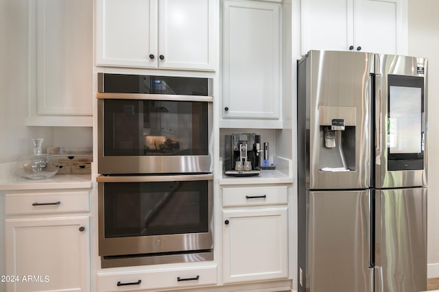 kitchen featuring appliances with stainless steel finishes and white cabinetry