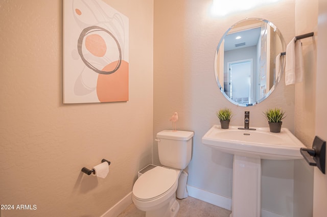 bathroom featuring tile patterned floors and toilet