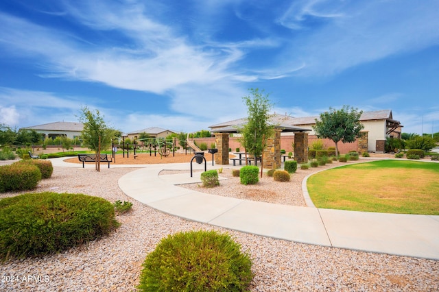 view of property's community with a lawn and a playground