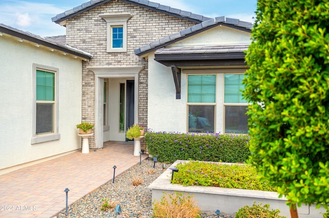 doorway to property featuring a patio