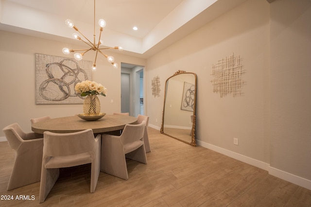 dining area featuring light hardwood / wood-style floors and an inviting chandelier