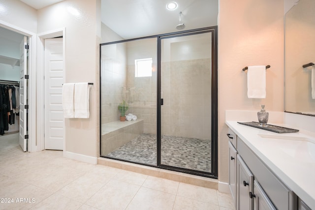 bathroom featuring vanity, tile patterned floors, and an enclosed shower