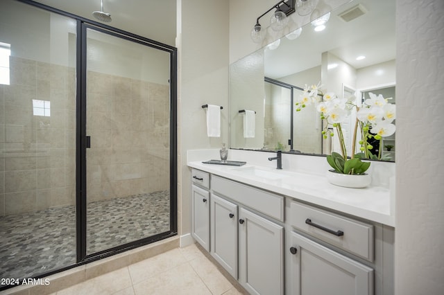 bathroom with vanity, tile patterned floors, and a shower with door