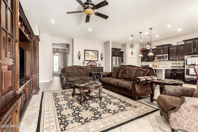 living area with a ceiling fan, recessed lighting, and light tile patterned floors