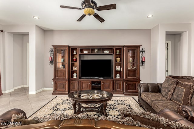 living area with light tile patterned floors, recessed lighting, a ceiling fan, and baseboards