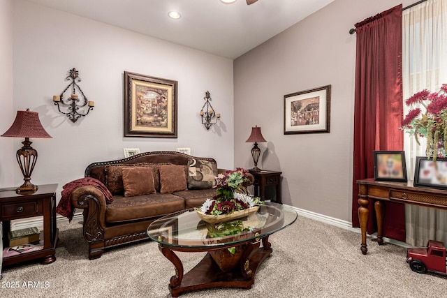 carpeted living area with recessed lighting and baseboards