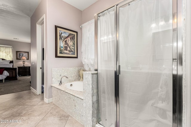 ensuite bathroom with a stall shower, baseboards, ensuite bathroom, tile patterned flooring, and a bath