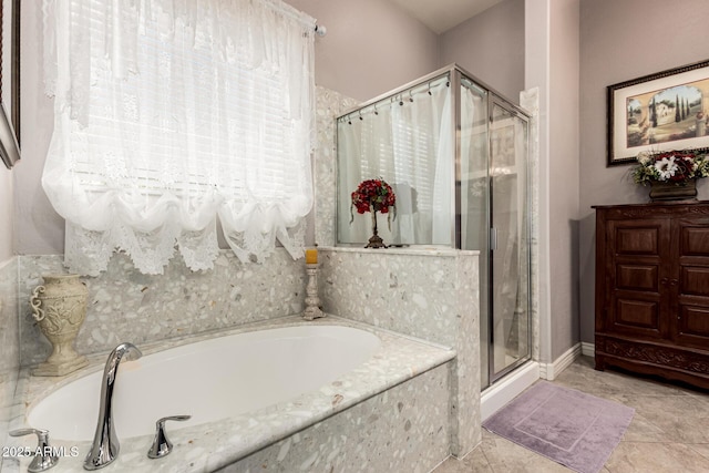 bathroom featuring a garden tub, tile patterned flooring, and a shower stall