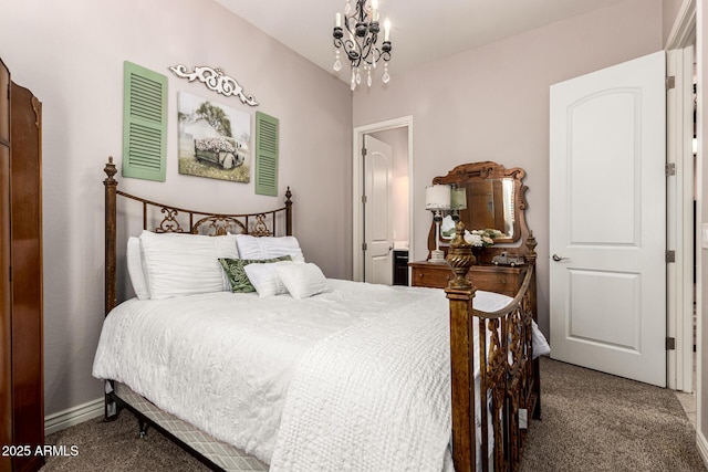 carpeted bedroom featuring an inviting chandelier and baseboards