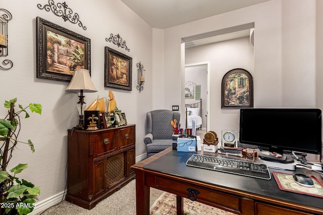 office space with baseboards and light colored carpet