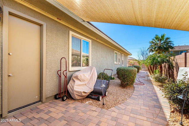 view of patio / terrace featuring a grill and fence