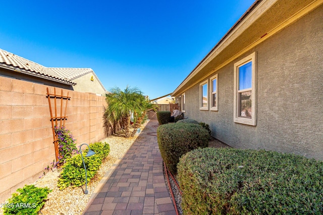 view of home's exterior with a fenced backyard and stucco siding