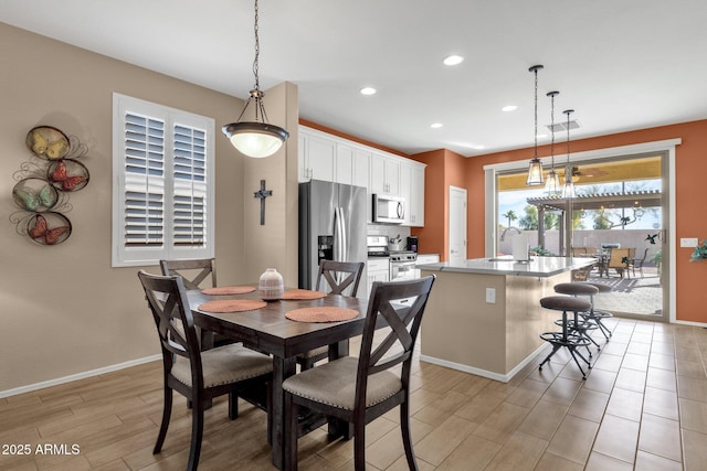 dining room with sink and light wood-type flooring