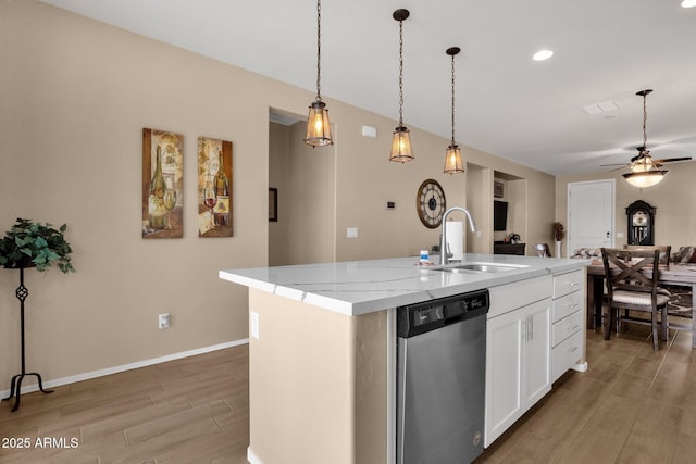 kitchen featuring sink, a kitchen island with sink, stainless steel dishwasher, and white cabinets