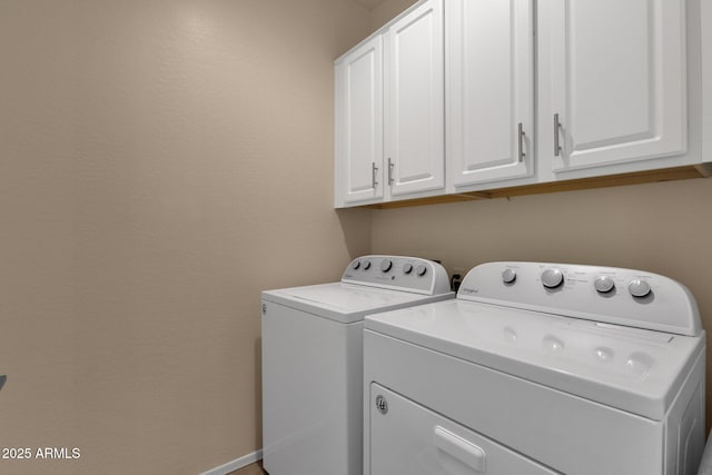 laundry room with cabinets and washing machine and dryer