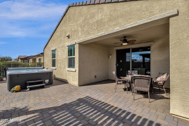 view of patio / terrace with a hot tub and ceiling fan