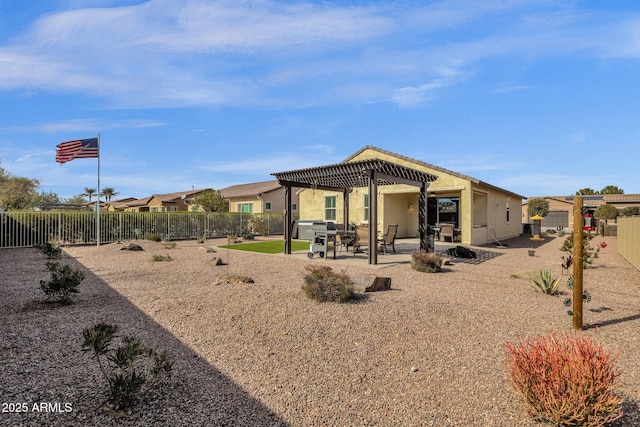 rear view of property with a pergola and a patio area