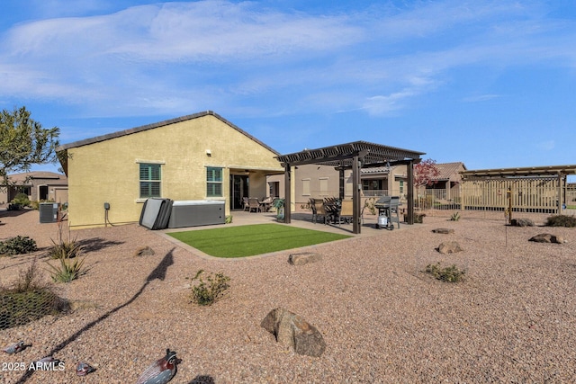 back of property featuring cooling unit, a hot tub, a pergola, and a patio