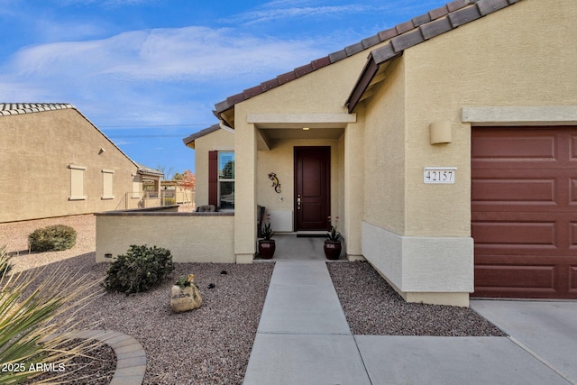 doorway to property with a garage