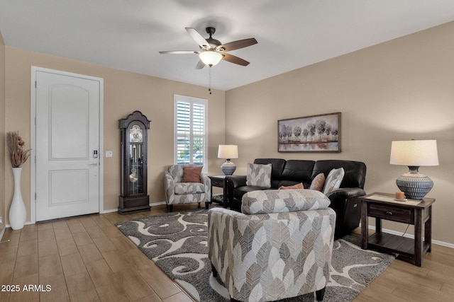 living room featuring light hardwood / wood-style floors and ceiling fan