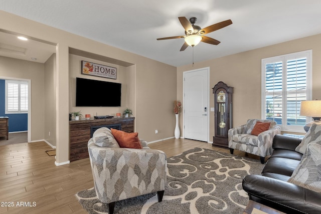 living room featuring wood-type flooring and ceiling fan