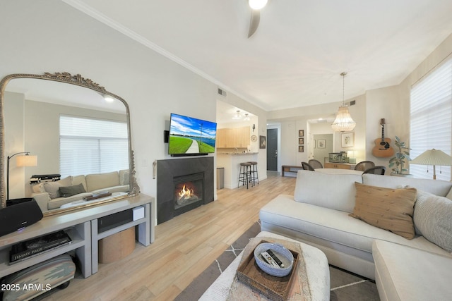 living room featuring crown molding and light wood-type flooring