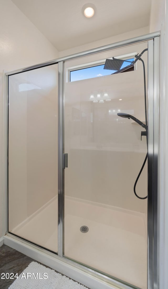 bathroom with a shower with door