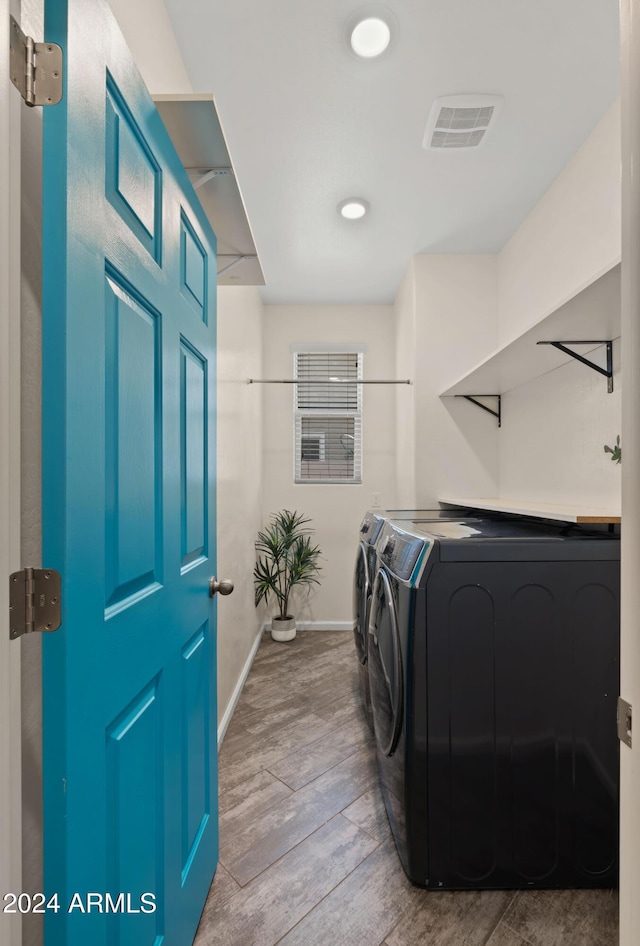 washroom featuring independent washer and dryer and light wood-type flooring