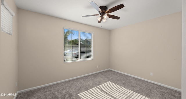 carpeted spare room featuring ceiling fan