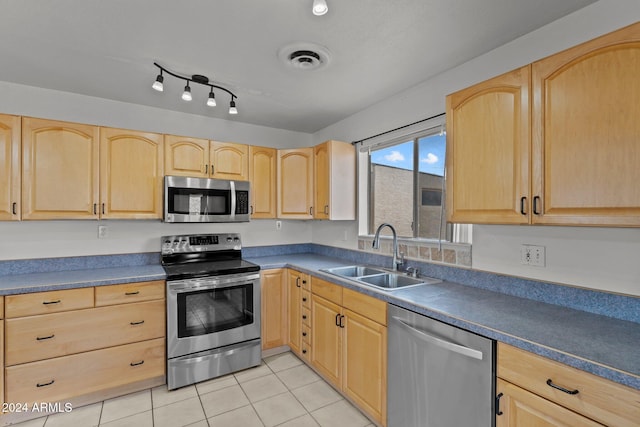 kitchen featuring light brown cabinets, light tile patterned floors, sink, and appliances with stainless steel finishes