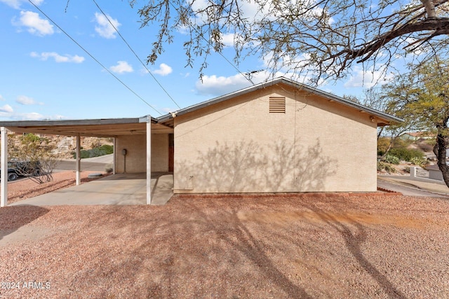 view of home's exterior featuring a carport