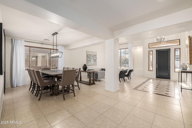 dining space featuring a notable chandelier and light tile patterned flooring