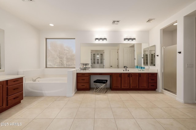 bathroom featuring shower with separate bathtub, tile patterned floors, and vanity