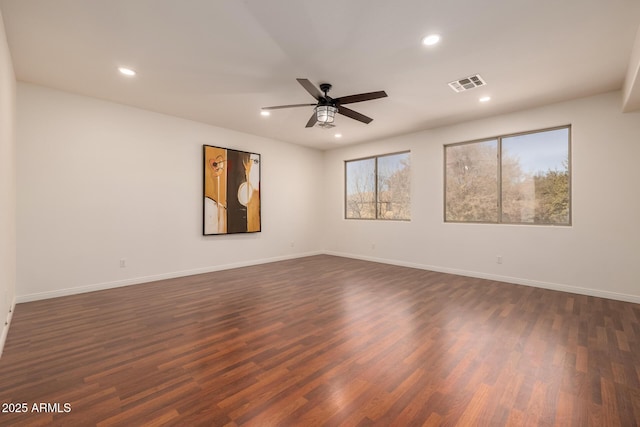 spare room featuring ceiling fan and dark hardwood / wood-style floors