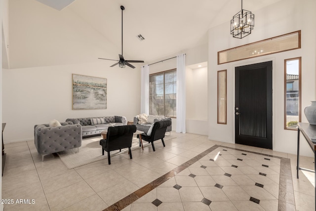 foyer entrance with ceiling fan with notable chandelier and light tile patterned floors