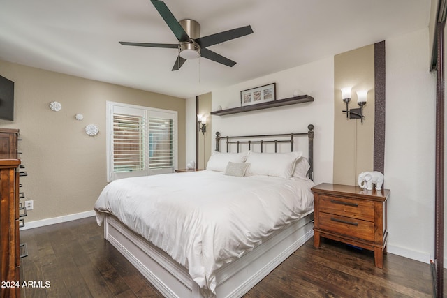 bedroom with a ceiling fan, baseboards, and wood-type flooring