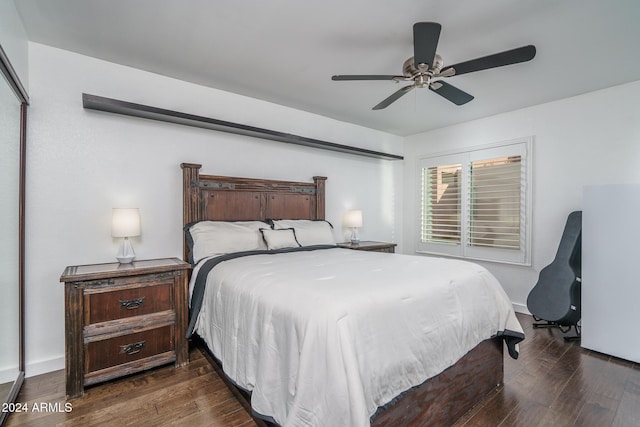 bedroom featuring a ceiling fan, dark wood-style flooring, and baseboards