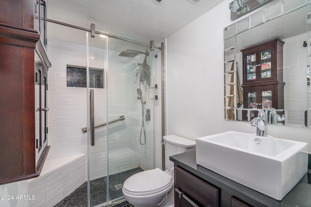 bathroom featuring a stall shower, toilet, and vanity