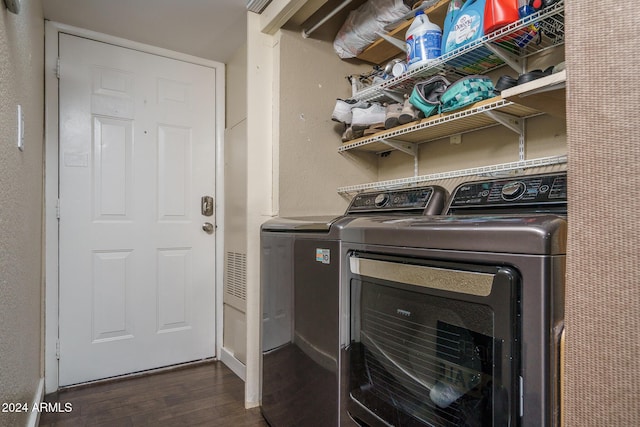 washroom featuring separate washer and dryer, dark wood-style floors, and laundry area