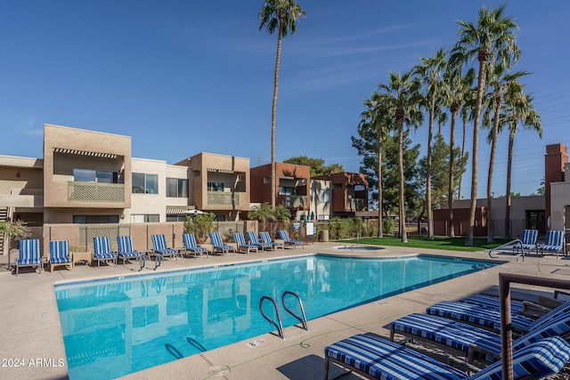 view of swimming pool with a patio area and fence