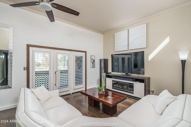 living area with a glass covered fireplace, wood finished floors, crown molding, baseboards, and ceiling fan