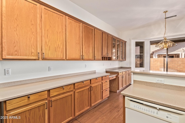 kitchen featuring light countertops, light wood-style floors, and dishwasher