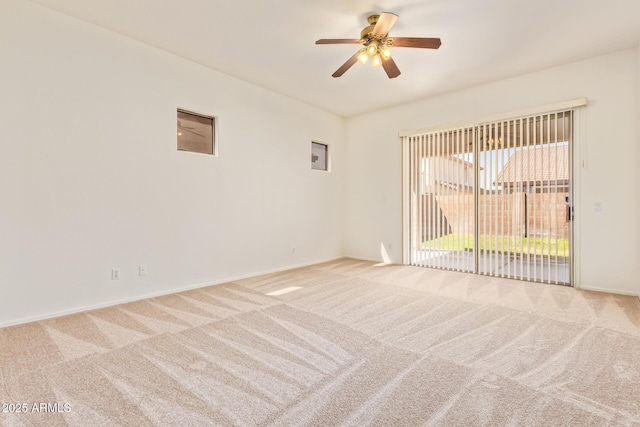spare room featuring carpet floors, baseboards, and ceiling fan