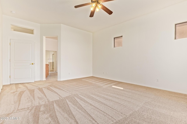 empty room with light colored carpet, baseboards, and ceiling fan