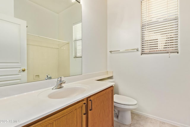 bathroom with vanity, tile patterned flooring, baseboards, and toilet