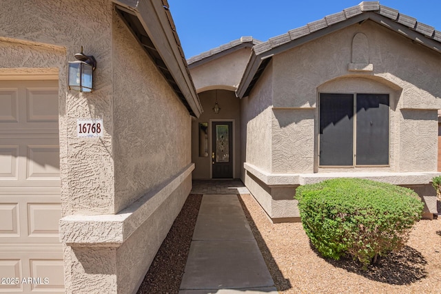 doorway to property with stucco siding