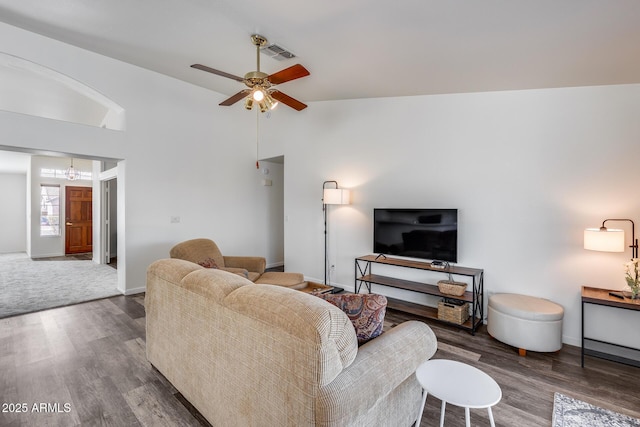 living area featuring visible vents, ceiling fan, baseboards, and wood finished floors