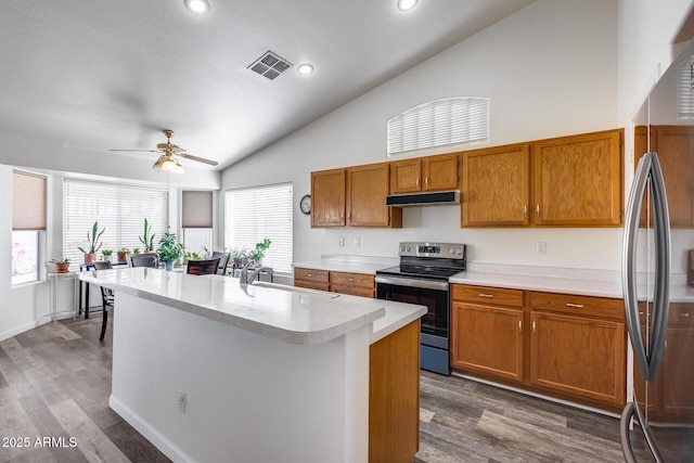 kitchen featuring light countertops, visible vents, appliances with stainless steel finishes, a sink, and under cabinet range hood